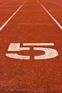 Number five on the start of a running track