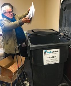 man throwing papers into bin