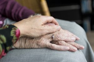 photo: woman's hand on older hand